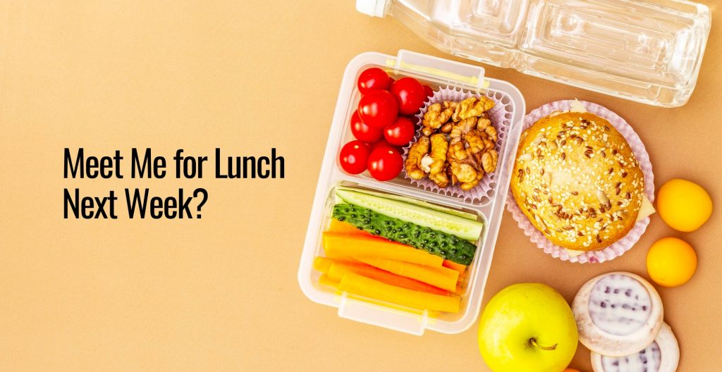 A collection of food like bread cheese lemon and a container with carrots cucumber tomatoes and nuts