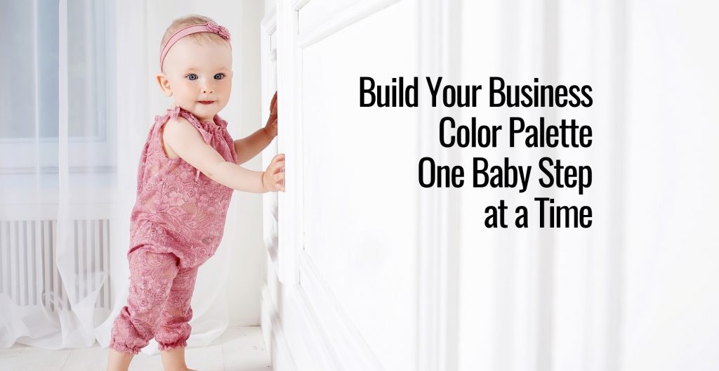 A cute baby holding onto the wall while learning to walk