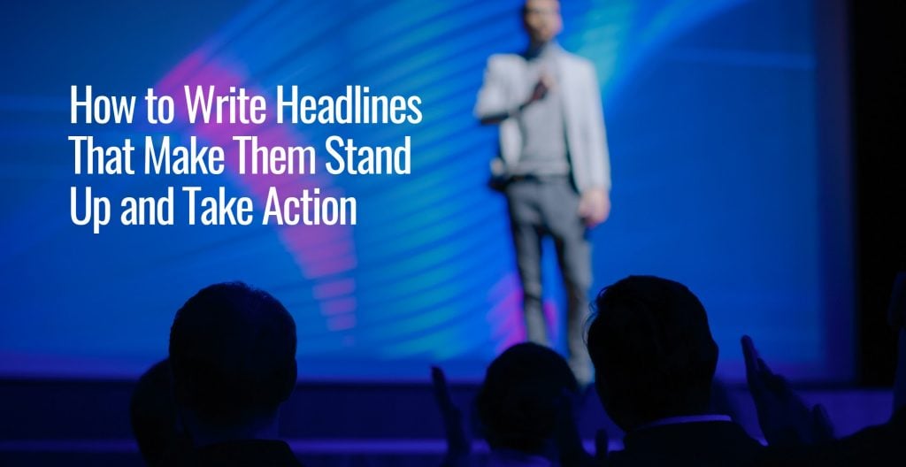 A blurred photo of a man standing on a stage in front of a lot of people