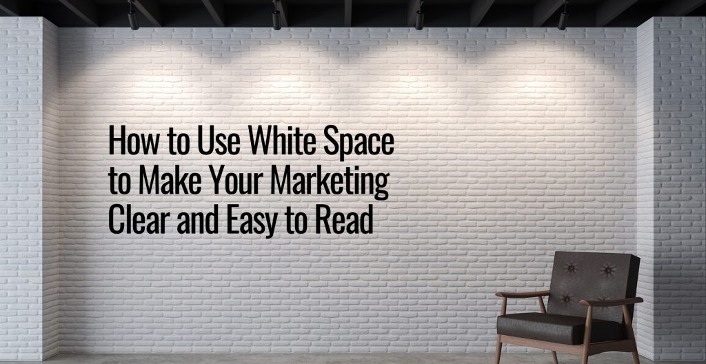 A white brick wall with 4 lights above and a wooden chair in the right corner