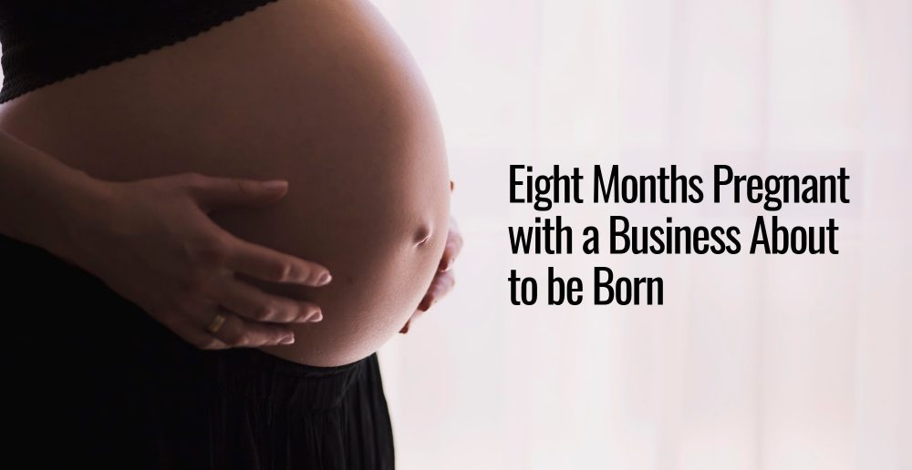 A very pregnant woman holding her belly